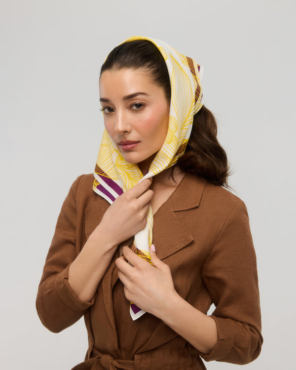 Yellow and white floral square scarf tied around the head, Princesse & Dragon Montréal