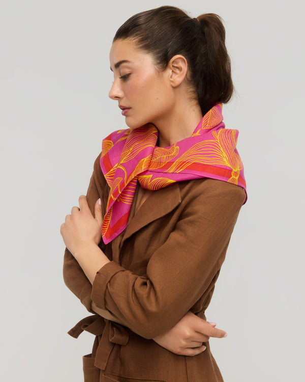Pink and orange floral square scarf tied around the neck, Princesse & Dragon Montréal