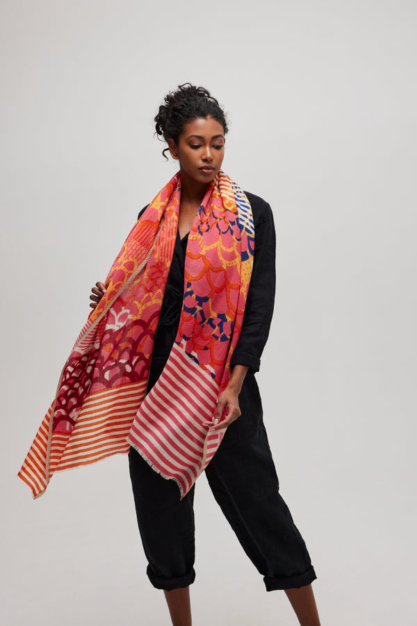 Orange and pink merino wool scarf with handcrafted subtle chevron pattern in relief, worn with style