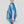 Foulard graphique en coton bleu et turquoise porté autour du cou Princesse & Dragon Montréal