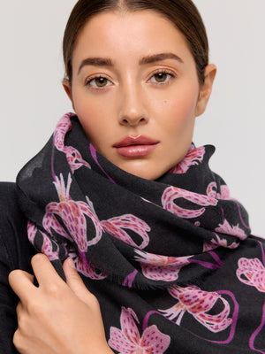 Foulard en laine mérinos avec motif floral, nuances de rose et violet sur fond noir, fabriqué à la main par Princesse & Dragon. Accessoire élégant pour rester au chaud