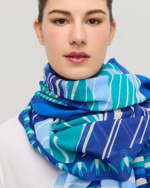 Blue and turquoise graphic cotton scarf worn around the neck Princesse & Dragon Montréal
