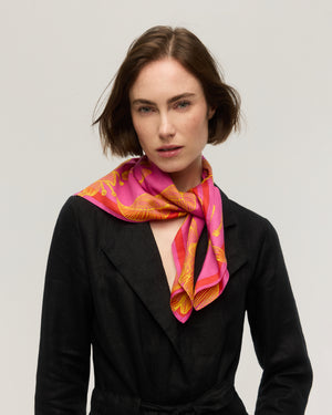 Fuchsia pink silk and cotton square scarf with yellow line-drawn floral print and orange border, loosely knotted at the neck, Princesse & Dragon