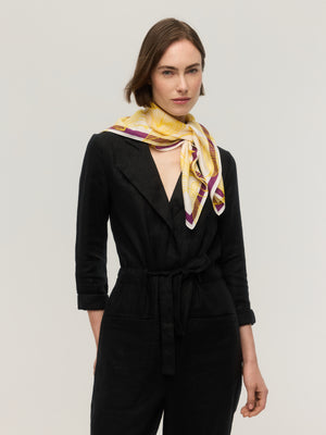 White silk and cotton square scarf with yellow line-drawn floral print and plum purple border, knotted at the neck, Princesse & Dragon