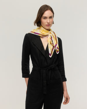 White silk and cotton square scarf with yellow line-drawn floral print and plum purple border, knotted at the neck, Princesse & Dragon